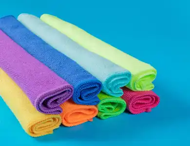 Rolled Microfiber Towels On Blue Background 1200X800